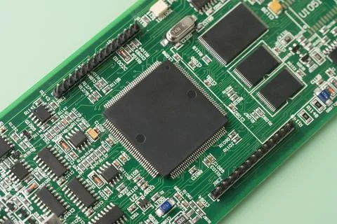 Electronic chip component. Printed circuit boards PCB on green background. Mi Stock Photos