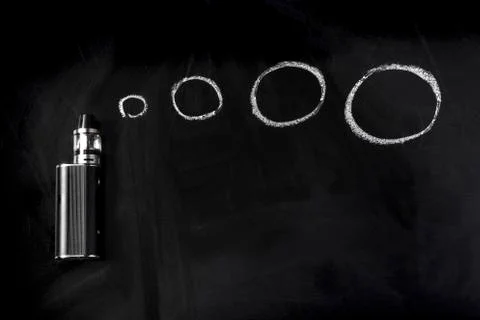 Electronic cigarette on a blackboard Stock Photos