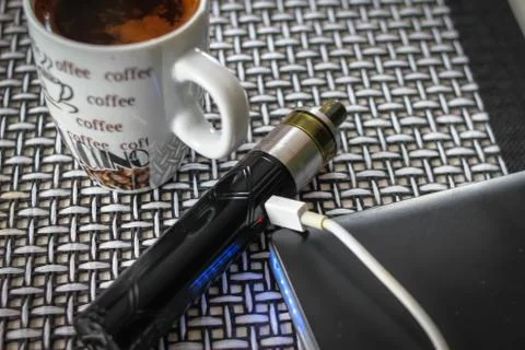 Electronic cigarette, computer keyboard and mouse Stock Photos