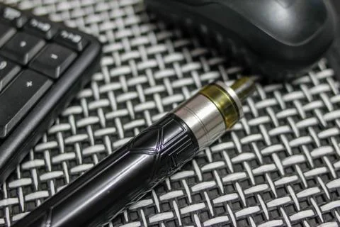 Electronic cigarette, computer keyboard and mouse Stock Photos