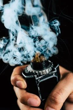 Electronic cigarette mechanical mod closeup. Centered on a black background Stock Photos