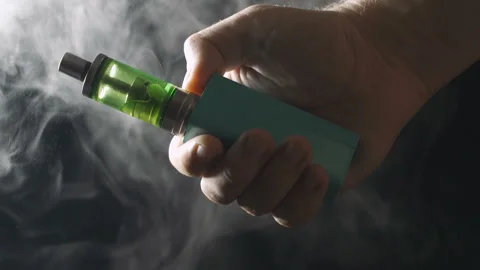 Electronic cigarette over a dark background Video stock 96249505