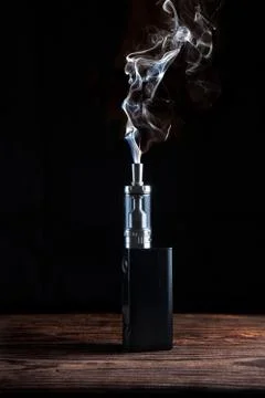 Electronic cigarette over a dark background Stock Illustration