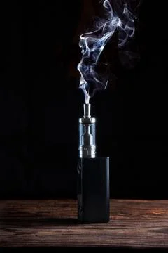 Electronic cigarette over a dark background Stock Illustration