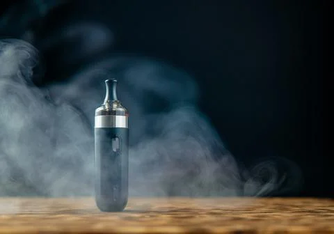 Electronic cigarette over a dark background Stock Photos