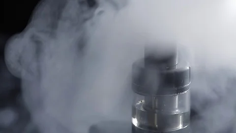 Electronic cigarette in the smoke - atomizer closeup Stock Footage 74874817