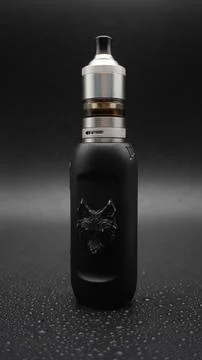 Electronic cigarette with wolf. Full HD. Black background. Stock Photos