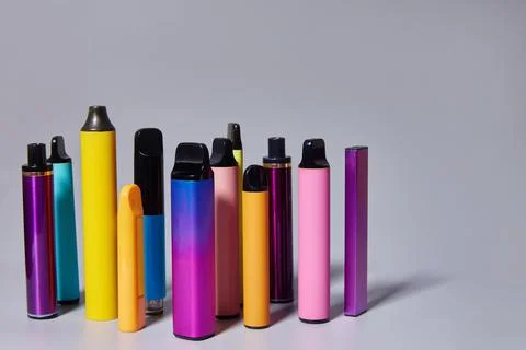 Electronic cigarettes are multicolored. Background for text or vape liquid Stock Photos
