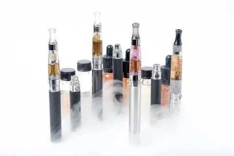 Electronic cigarettes with e-juice bottles with smoke Foto stock