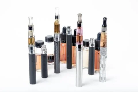Electronic cigarettes with e-juice bottles on white background Foto stock