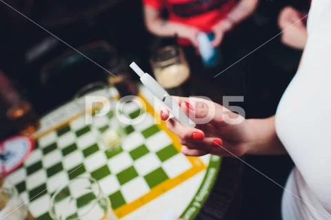Electronic cigarettes, technology cigarette. Tobacco system IQOS. Female hand on Stock Photos