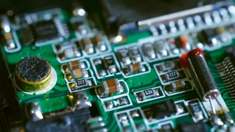 Electronic circuit board components close-up showing resistors, capacitors, and Stock Footage 310521400