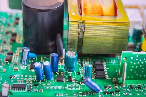 Electronic circuit board of computer with electronic parts close up. Stock Photos