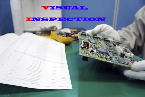 Electronic circuit board inspecting close up with word "VISUAL INSPEXTION" Stock Photos