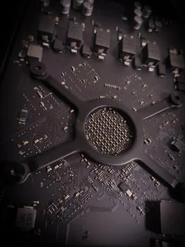 Electronic circuit board with processor and metal components, showing old c.. Stock Photos