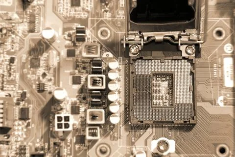 Electronic circuit boards on brown background with CPU socket, selective focu Stock Photos