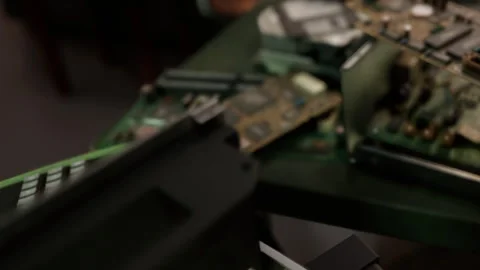 Electronic Circuit Boards Stacked on a Table for Repair Work Inside a Workshop Stock Footage 348244959