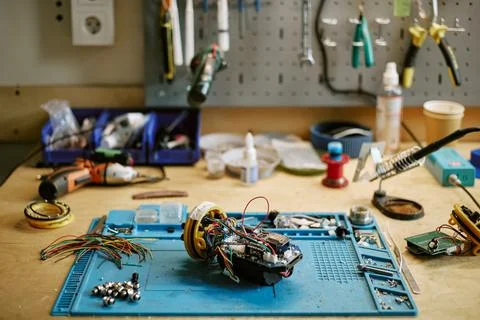 Electronic Components and Robotic Device on Workbench in Workshop Stock Photos