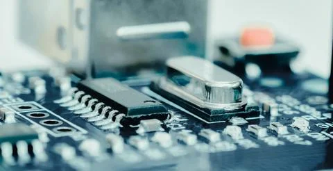 Electronic components, chips and capacitors on the blue pcb, close up view... Stock Photos
