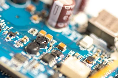 Electronic components, chips and capacitors on the blue pcb, close up view. T Stock Photos