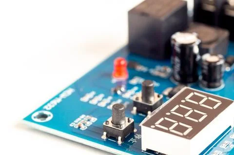 Electronic components, chips and capacitors on the blue pcb, close up view... Stock Photos