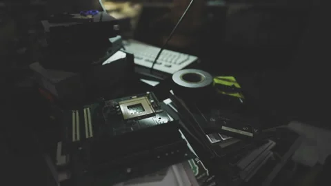 Electronic components spread out in dimly lit repair environment Stock Footage 342438115