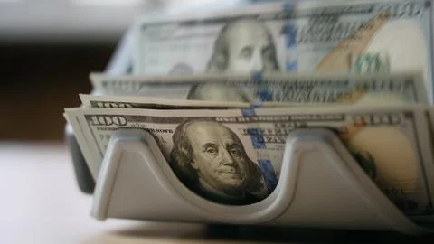 Electronic counter calculating dollar banknotes close up. Money cash calculation Stock Photos