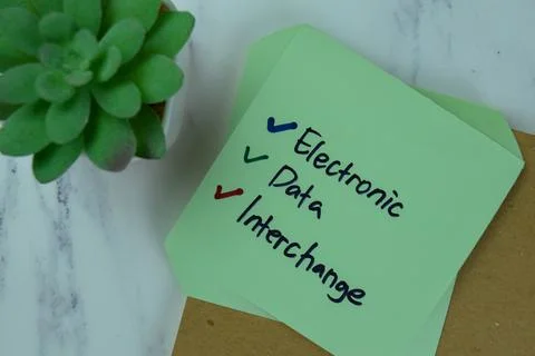 Electronic Data Interchange write on sticky notes isolated on Wooden Table. Stock Photos