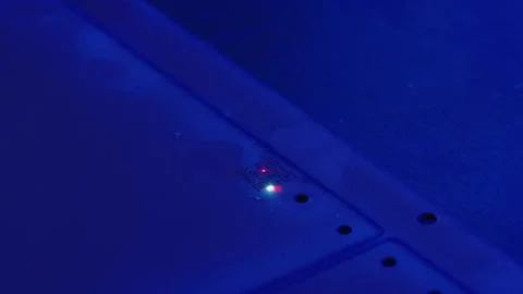 Electronic device emitting red and green light with qr code in blue light 写真素材