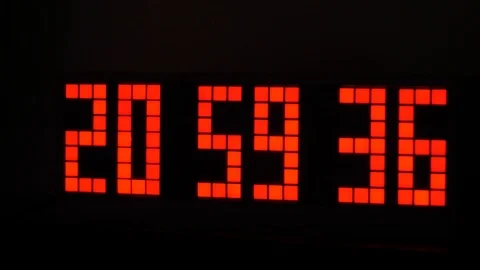 Electronic digital clock on a black background Stock Footage 101364264