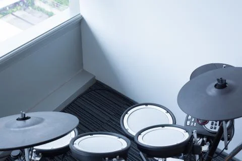 Electronic drum set in the room corner as musical background technology theme Foto stock