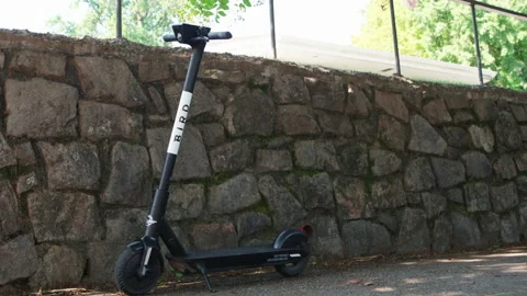 Electronic E-Scooter Bird Sits on Sidewalk in Suburban Neighborhood Stock Footage 130866676