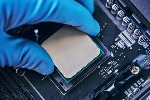 Electronic engineer of computer technology. Installing the processor on the Stock Photos