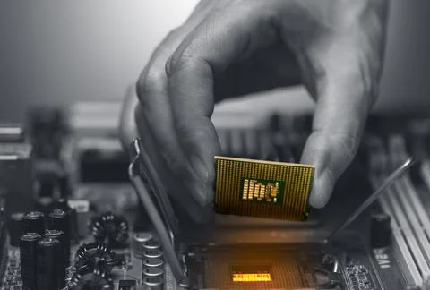 Electronic engineer hand putting computer chip on socket. Chipset on electron Stock Photos