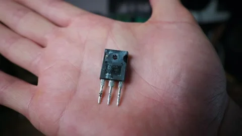 Electronic Engineer Holding a Power Transistor Component in Open Palm Stock Footage 339363755