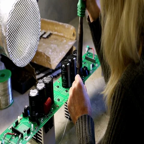 Electronic engineers are busy assembling and testing motherboards Stock Footage 69548158