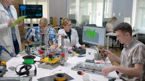 Electronic engineers watching 3d printer printing Stock Footage 97572832