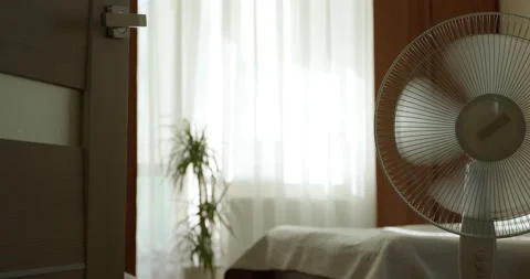 An electronic fan cools the room on a hot summer day. Stock Footage 196822395