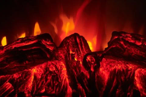 Electronic fireplace with red and yellow flame, close up. Stock Photos