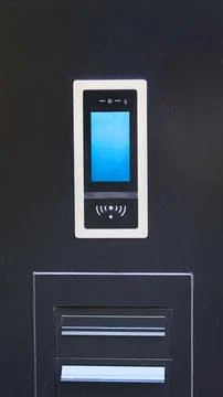 Electronic intercom panel and mailboxes on a wall. Stock Photos