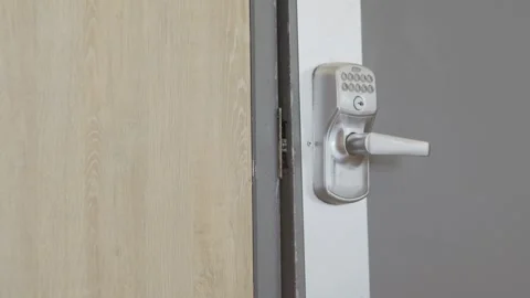 Electronic keypad door lock handle on commercial building entry door Stock Footage 342084967