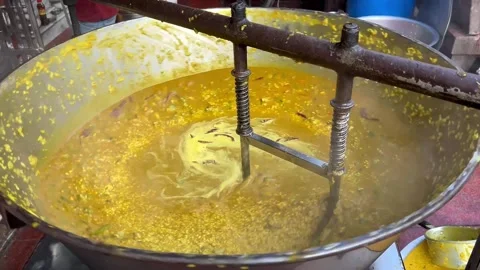 An electronic khichdi-making machine in action at Varanasi ghat street Stock Footage 285829953