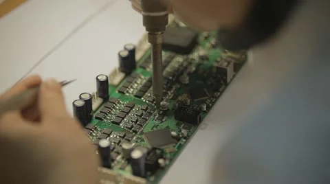 Electronic lab working place with soldering iron and circuit board Stock Footage 64990492