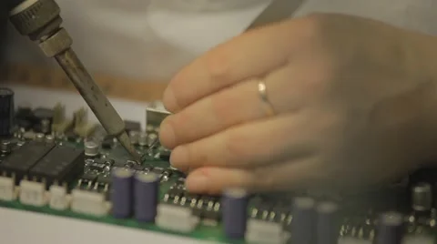 Electronic lab working place with soldering iron and circuit board Stock Footage 65300775