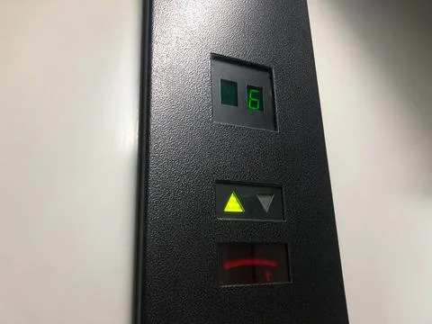 Electronic led elevator display showing the lift moving up to the sixth floor Stock Photos