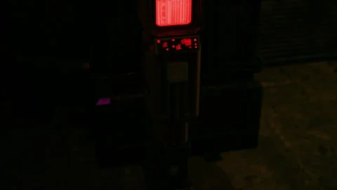 Electronic Machine Displaying Glowing Red Data in a Dark Room at Night Time Stock Footage 348694462