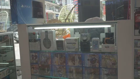 Electronic materials and video games for sell in a glass box Stock Footage 97116641