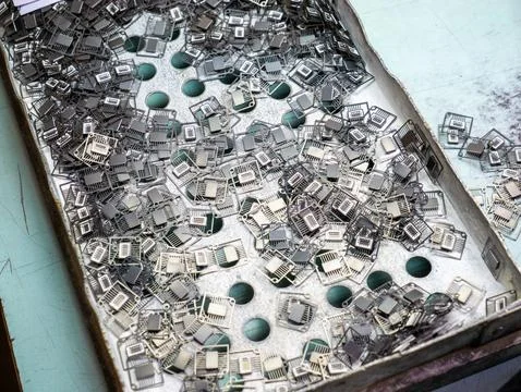 Electronic Microchip Components and Lead Frames in Metal Factory Tray Stock Photos