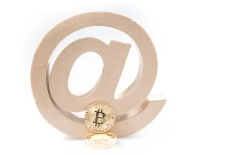 Electronic money concept symbol with an at arroba and golden bitcoin for net  Stock Photos