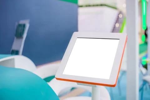 Electronic multimedia tablet kiosk with blank white display at exhibition Stock Photos